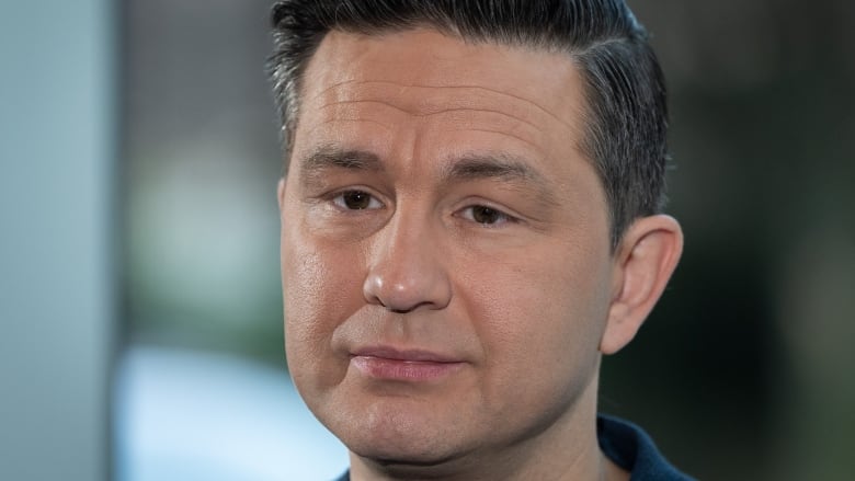 Conservative Leader Pierre Poilievre listens to media questions during a news conference on safety in hospitals in Vancouver