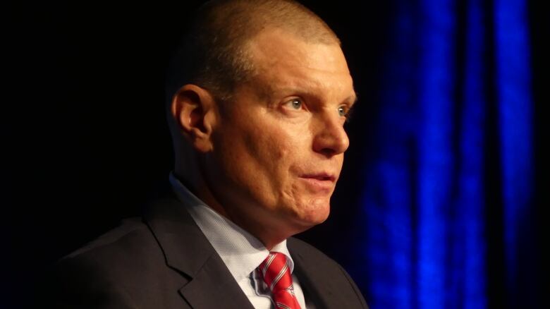 A man in a suit with a red tie.