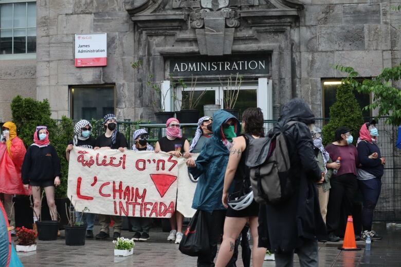 protesters carry a banner saying 