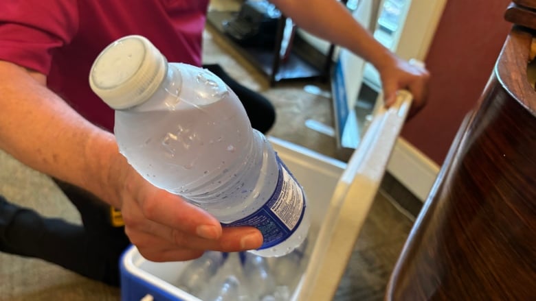 hand holding water bottle