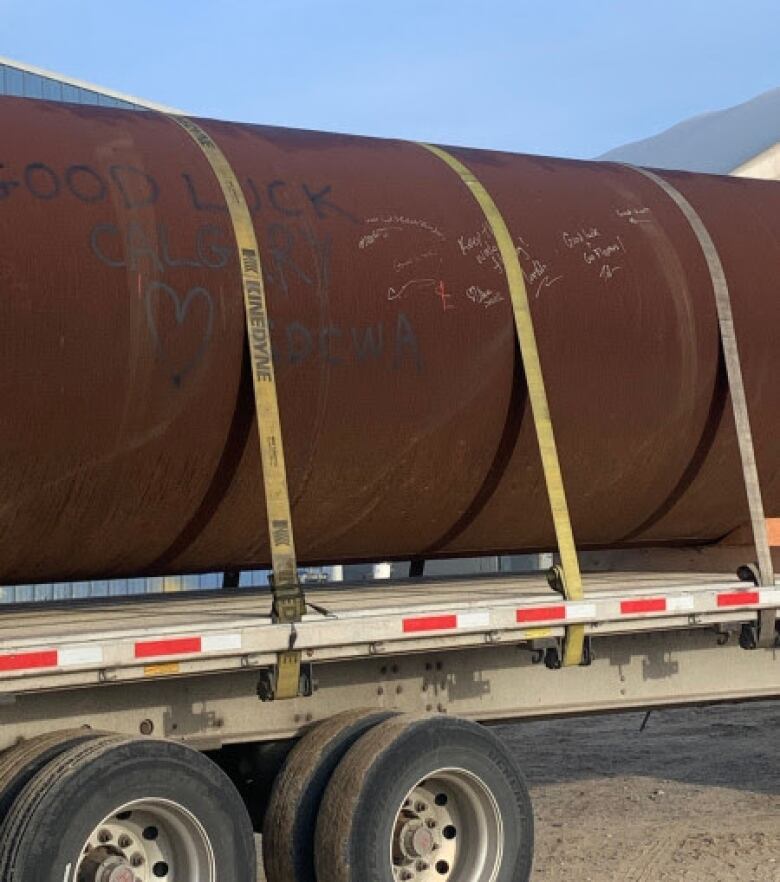 a large brown pipe on a large truck.