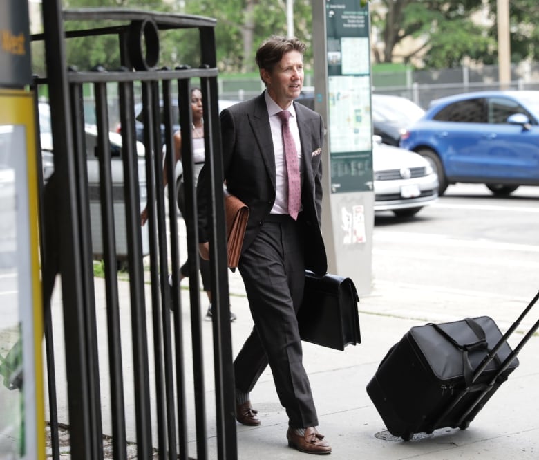 Photograph showing Toronto lawyers Nicholas Cartel, left, and Trung Nguyen, right, leaving the courthouse at 330 University Ave. in downtown Toronto in the early afternoon of Thursday, June 20, 2024.