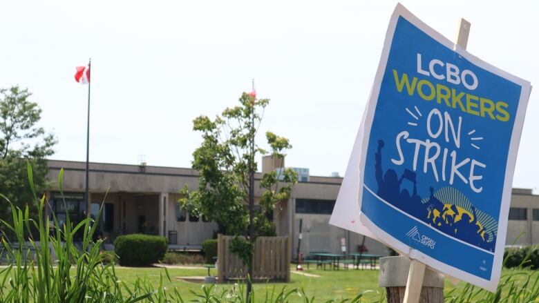 A picket sign leaned against the fence that surrounds the LCBO's London Logistics Facility on Monday, just metres away from striking workers.