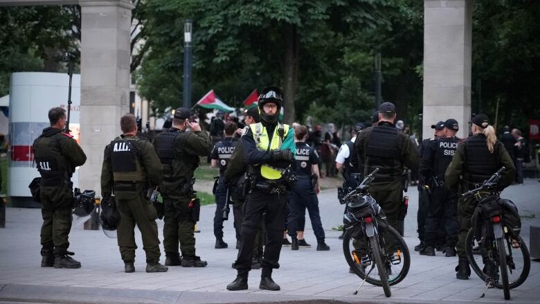 Police surround a Palestinian encampment. 