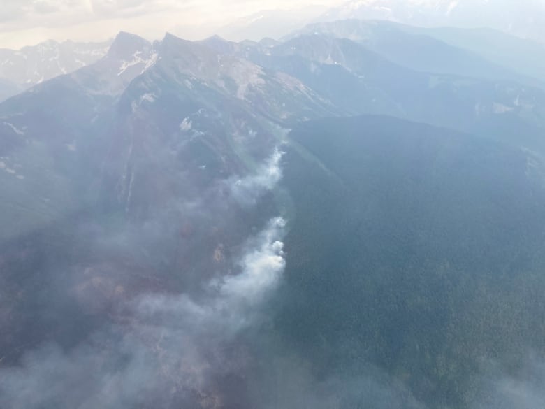 smoke rising over hills 