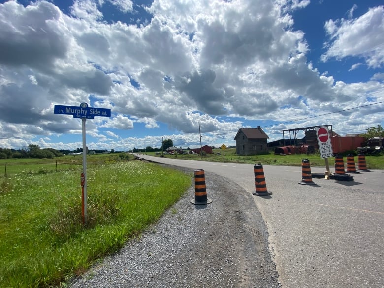 Orange and black pylons are spread across Murphy Side Road in west Ottawa, with a 