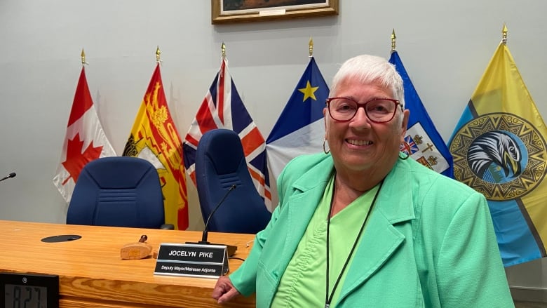 Jocelyn Pike stands in Fredericton council chambers.