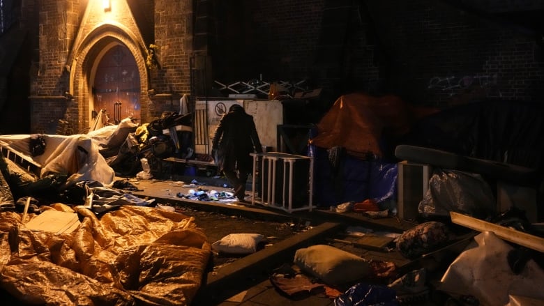 An encampment seen in front of a church.