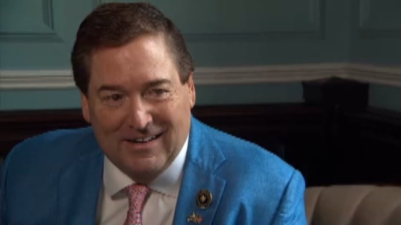 Man in blue suit and red tie.