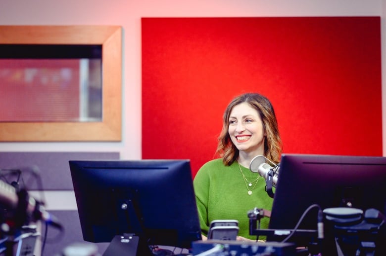 A woman in a recording studio smiling