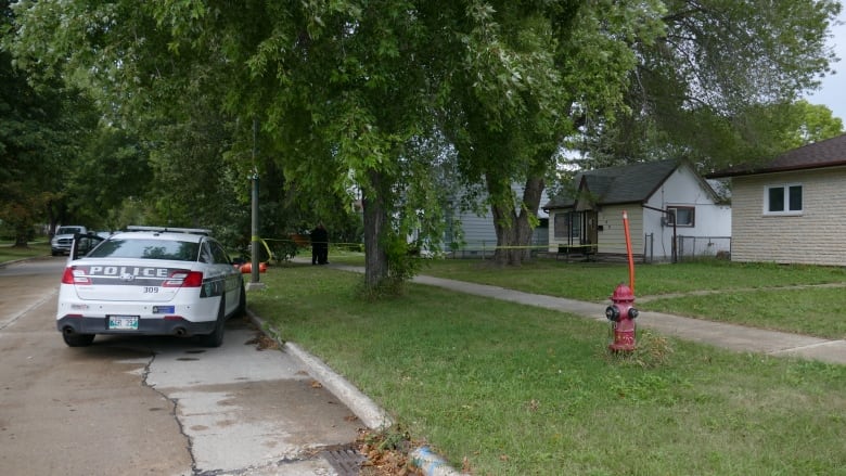 A police car is outside a home. 