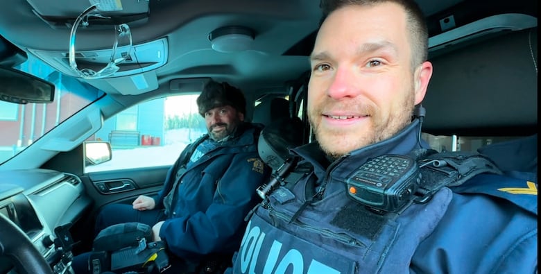 Two RCMP officers sit in a truck 