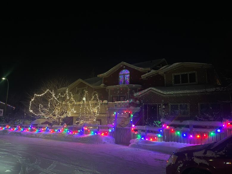 A large home lit up with Christmas lights